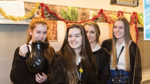 Sixth form students offer coffee with a smile