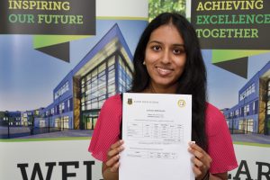 Abisa Arivalagan from Alsop High School holding up her results