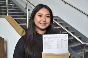 St Julie's student Cai with their GCSE results