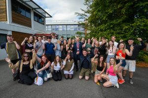 Students from St John Rigby College celebrate with principal Peter McGhee