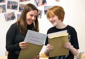 Students from Sacred Heart Catholic Academy smile happily after taking a look at their GCSE results