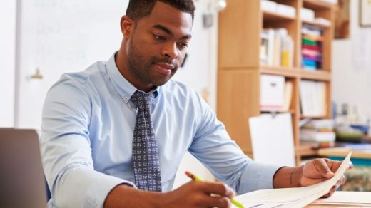 Teacher sat at desk