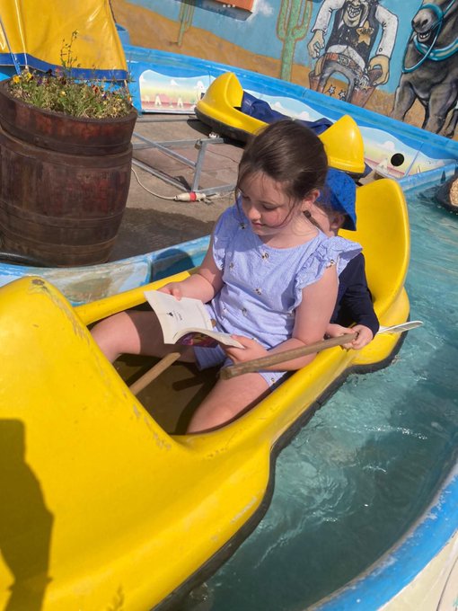 Child reading in boat