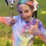 A Shoreside student with their thumbs up, after taking part in the run