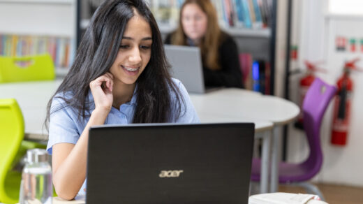 Student smiling looking at laptop