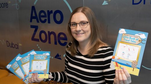 Manchester Airport Education Manager, Joanna Jackson, with the 2023Little Book of Travel Tales at the AeroZone education centre