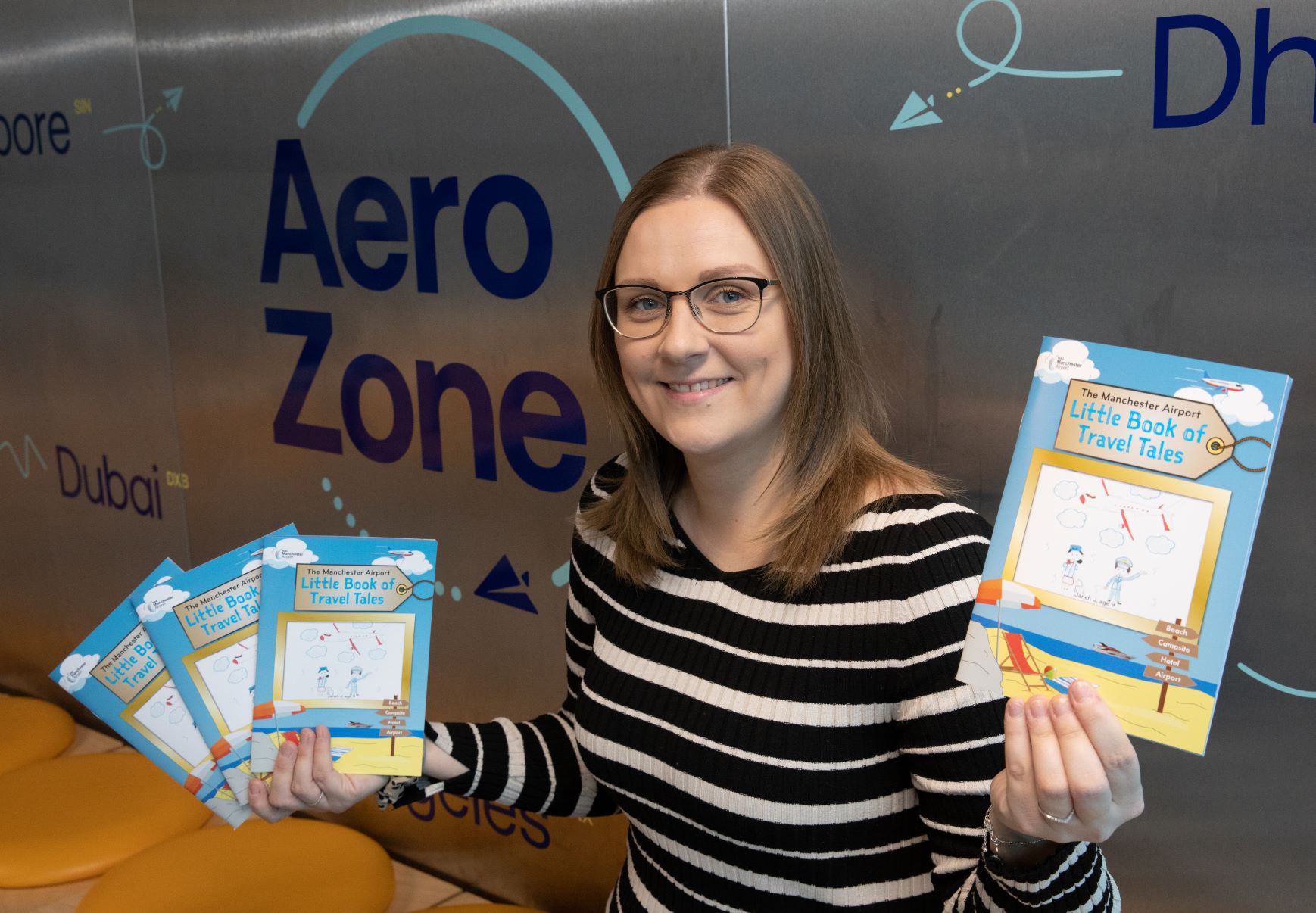 Manchester Airport Education Manager, Joanna Jackson, with the 2023Little Book of Travel Tales at the AeroZone education centre