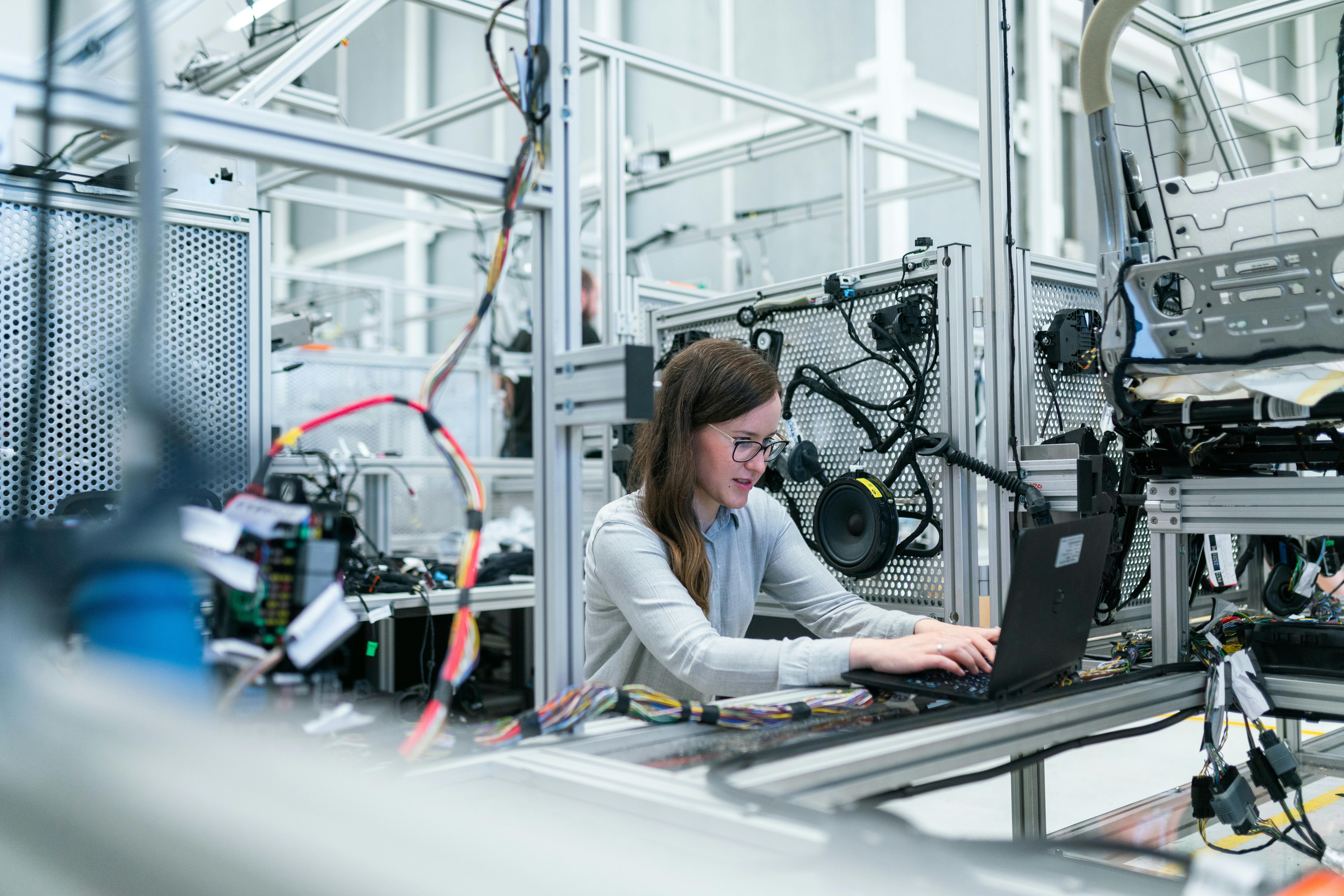 Female Engineer Working On Her Workspace by ThisIsEngineering
