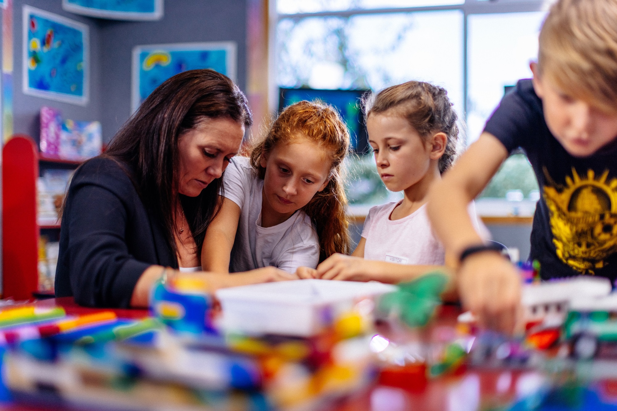 A teacher and students using the Brick-by-Brick® programme