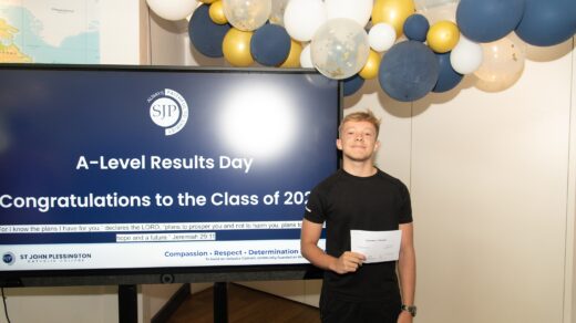 St John Plessington Catholic College student holding up his results